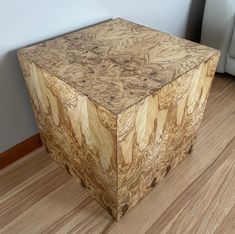 a wooden box sitting on top of a hard wood floor