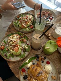 three plates of food on a wooden table