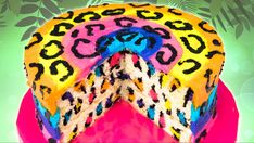 a multicolored leopard print cake on a pink plate