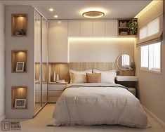 a bedroom with a bed, mirror and lights on the headboard is lit by recessed lighting