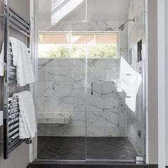 a walk in shower sitting inside of a bathroom