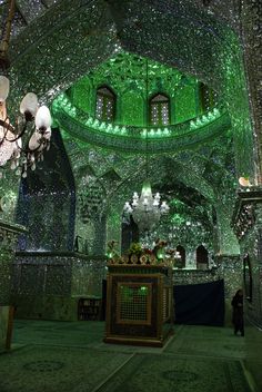 the inside of a building with green lights and chandeliers