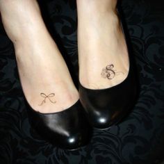 a woman's foot with a small bow tattoo on her left ankle and the word love written in cursive writing