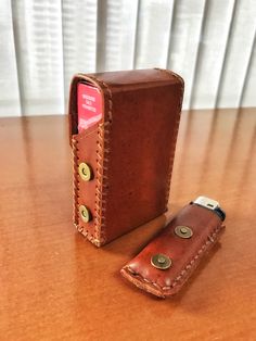 a leather wallet sitting on top of a wooden table