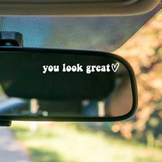 you look great sticker on the side mirror of a car with trees in the background