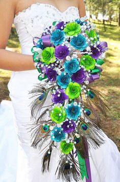 a wedding bouquet with peacock feathers and flowers on the bottom is featured in an instagram