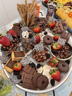 an assortment of chocolates, strawberries, and other treats on a platter