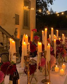 a table with candles and flowers on it