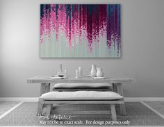 an abstract painting on the wall above a dining room table