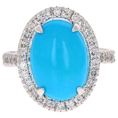 Beautiful Turquoise Diamond Cabochon Cocktail Ring! The Oval Cut Cabochon Turquoise is 4.79 Carats and has a halo of 32 Round Cut Diamonds weighing 0.47 Carats. The total carat weight of the ring is 5.26 Carats. It is crafted in 14K White Gold and is approximately 6.8 grams. The ring is a size 7 and can be resized free of charge. Antique Turquoise Jewelry, Coloured Stone Rings, Yellow Gold Cocktail Ring, Gold Cocktail Ring, Diamond Jewelry Designs, Gold Cocktail, Diamond Cocktail Rings, Turquoise Rings, Silver Engagement Rings