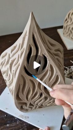 someone is making a sculpture out of clay