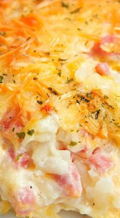 a casserole with ham and cheese on it is sitting on a white plate