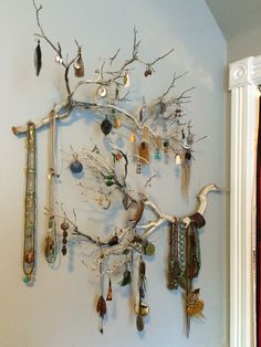 there is a tree with many different items hanging on it's branches and birds