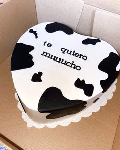 a cake in the shape of a cow with spanish writing on it