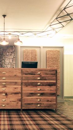 a large wooden dresser sitting on top of a carpeted floor next to a wall