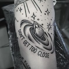 a black and white photo of a man's arm with tattoos on it that says don't get too close