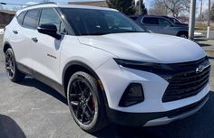 a white chevrolet suv parked in a parking lot