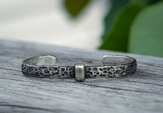 The style of the bracelet reflects the meticulous craftsmanship of a 1700's blacksmith shop. An antiqued hammered finish covers the surface, and is accented by a band down the middle of the bracelet. Smoothly edged for comfortable everyday wear, each cuff is individually made to order from a premium sterling silver with 93.5% purity. This is a solid, substantial bracelet and would make a great gift for anyone who loves Scottish, Celtic, or Viking flare (or is a fan of the Outlander Series. ) Eac Outlander Style, Medieval Rings, Blacksmith Shop, Carved Ring, Hammered Sterling Silver, Cuff Detail, Sterling Silver Cuff, Memento Mori, Silver Cuff Bracelet