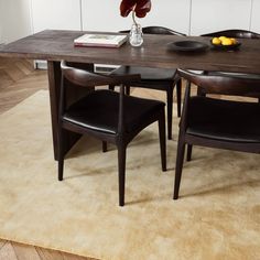 a table with two chairs and a bowl of fruit on it