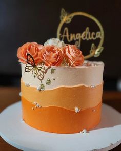 an orange and white cake with flowers on top