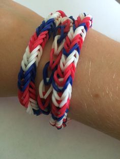 a close up of a person's arm wearing two different colored bracelets on it