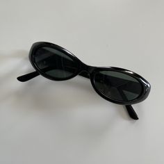 These slim round oval sunglasses are your everyday classic. Featuring a black frame with smoke lens. This style is unisex. True genuine vintage sunglasses from the 90s.  - 400 uv  -Material:  polyurethane frame , steel arms embedded within frame and glass lens  - new vintage from the 90s - includes sunglasses pouch Vintage Black Plastic Sunglasses, Minimal Sunglasses, Black Oval Sunglasses, Black Sunnies, Indie Photography, 90s Sunglasses, Sunglasses Pouch, Pretty Shoes Sneakers, Crochet Keychain Pattern