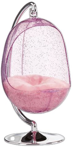 a glass ball with pink liquid in it sitting on top of a metal stand,