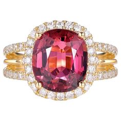 This exquisite ring is a stunning piece of jewelry crafted in luxurious 18-karat yellow gold. At its center is a captivating 4.01-carat cushion-cut tourmaline, displaying a rich and vibrant hue that draws the eye. The tourmaline is elegantly framed by a halo of sparkling diamonds, totaling 0.75 carats, which enhance its brilliance and add a touch of opulence. The band features a delicate pavé setting of diamonds, creating a continuous shimmer that complements the central gemstone beautifully. Th Fancy Diamond Ring, Yellow Diamond Rings, Diamond Cocktail Rings, Fancy Diamonds, Modern Ring, Pink Ring, Elegant Ring, Elegant Accessories, Yellow Diamond