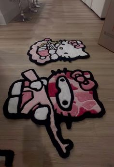 two rugs with hello kitty designs on the floor