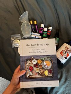 the first forty days book is sitting on a bed next to an assortment of essentials