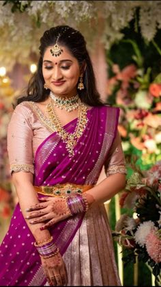 a woman in a purple and gold sari