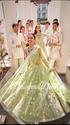 a group of people standing around each other in front of a bride and grooms