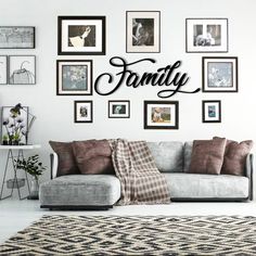 a living room filled with furniture and lots of framed pictures on the wall above it