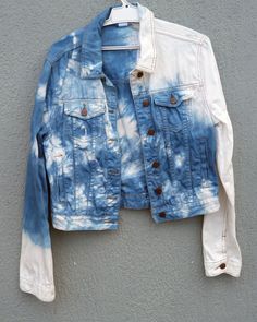 a blue and white jacket hanging on a wall