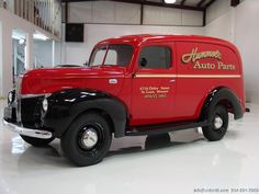 an old red truck parked in a garage