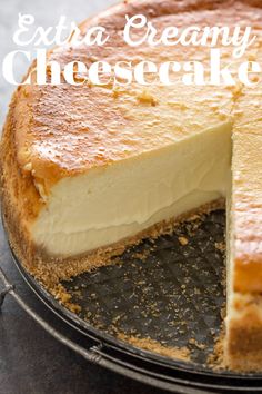 a cheesecake on a plate with the words extra creamy cheesecake