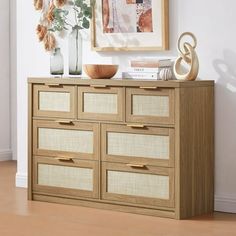 an image of a dresser with drawers and vases on it's sideboard