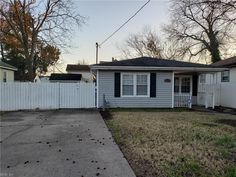 a small house with a white picket fence