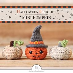 three small crocheted pumpkins sitting next to each other