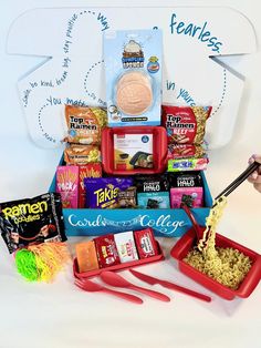 an assortment of snacks and condiments are arranged on a white surface with scissors