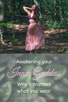 a woman standing in the woods with her arms behind her head, wearing a pink dress