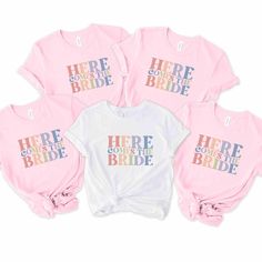 four pink and white shirts with the words here comes the bride written on them in different colors