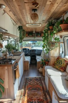 the interior of an rv with plants and rugs