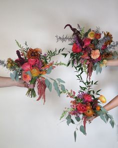 three hands holding different types of flowers in their palm's up to the camera