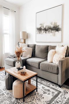 A neutral living room with a grey couch, woven decor, and soft neutral tones. Neutral Living Room Grey Couch, Living Rooms With Grey Couches, Room With Grey Couch, Living Room With Grey Couch, Dark Couch Living Room, Living Room Grey Couch, Charcoal Grey Couch, Neutral Living Rooms, Dark Couch