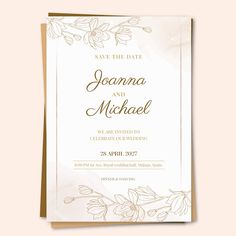 an elegant wedding card with gold foil and flowers on the front, in white paper