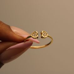 Discover sophistication with our elegant 14k gold band ring, boasting a delicate design that embodies modern minimalism. Its dainty form is accentuated by two hearts, each cradling a shimmering cubic zirconia stone that catches the light with every movement. P R O D U C T ∙ M E A S U R E M E N T S * 100% 14k Solid Gold * Weight: 1.26g  *  Stone Diameter: 5mm/ 0.2 inch  * Band Width: 1.5mm/ 0.1 inch  Delivery:  * Ready to ship in 1 business day. * Delivers in 1 to 5 days depending on location and delivery option. * Returns are accepted within 7 days from the delivery date, at the customers cost. Gift Option: * We cherish the joy of gifting, as do you and your loved ones. Feel free to inform us if            you desire an additional personalized note with your order to make it an even more Minimalist Open Heart Ring For Anniversary, Elegant Heart-shaped Midi Rings For Promise, Elegant Heart-shaped Midi Promise Rings, Minimalist Gold Heart Ring For Promise, Elegant Heart Ring Tarnish Resistant For Anniversary, Elegant Hypoallergenic Midi Rings For Promise, Promise Heart Ring In Fine Jewelry Style, Delicate Yellow Gold Heart Ring For Promise, Elegant Promise Ring With Simple Heart Design