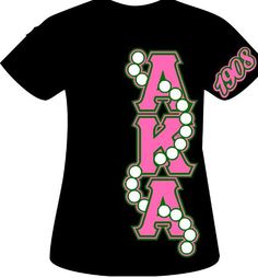 the back of a black shirt with pink and green letters that spell,'aora '