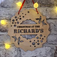 a wooden sign that says christmas at the richard's hanging on a brick wall