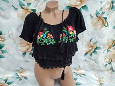 90s Vintage women's black crop top with ruffle floral embroidery. Size S-M. Crop top in excellent vintage condition. Bust 90cm (35.4in), Top Length 33cm (13in). Summer Festival Crop Top With Floral Embroidery, Bohemian Fitted Crop Top With Floral Embroidery, Fitted Bohemian Crop Top With Floral Embroidery, Fitted Floral Embroidery Crop Top For Festival, Fitted Floral Embroidered Crop Top For Festival, Embroidered Fitted Casual Crop Top, Casual Embroidered Fitted Crop Top, Embroidered Fitted Crop Top For Summer, Black Short Sleeve Crop Top For Spring